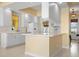 Well-lit kitchen with white cabinets, modern appliances, and an eat-in breakfast bar at 5663 Novara Pl, Sarasota, FL 34238