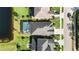 An aerial view highlights a home's screened pool, outdoor living space, and proximity to the lake at 6161 Anise Dr, Sarasota, FL 34238