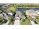 Single-Gathering home with a screened in lanai that overlooks a pond, lush landscaping, and a two car garage at 6161 Anise Dr, Sarasota, FL 34238