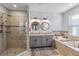 Bathroom with double vanity, decorative mirrors, spacious shower, and a soaking tub for relaxation at 6161 Anise Dr, Sarasota, FL 34238