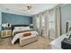 Comfortable bedroom with stylish blue accent wall, soft carpeting, and a well-lit, inviting atmosphere at 6161 Anise Dr, Sarasota, FL 34238