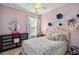 Charming pink bedroom with a comfortable bed, decorative accents, and a cozy, personalized atmosphere at 6161 Anise Dr, Sarasota, FL 34238