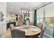 Open-concept dining area with natural light, view of the kitchen and pendant lighting at 6161 Anise Dr, Sarasota, FL 34238