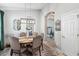 Formal dining room with a round table set for six, modern lighting and elegant decor at 6161 Anise Dr, Sarasota, FL 34238