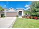 Charming single-Gathering home featuring a well-manicured lawn and colorful flowerbeds at 6161 Anise Dr, Sarasota, FL 34238