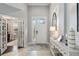 Open and airy foyer with white accents, a decorative rug, and a console table at 6161 Anise Dr, Sarasota, FL 34238