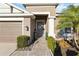Inviting front entrance with stone pathway, manicured bushes and beautiful plants with pops of color at 6161 Anise Dr, Sarasota, FL 34238