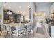 Island kitchen with a large central island, bar stool seating, pendant lights and view of hallway at 6161 Anise Dr, Sarasota, FL 34238