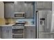 Kitchen features stainless steel appliances, granite countertops, and modern gray cabinets at 6161 Anise Dr, Sarasota, FL 34238