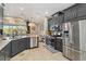 Spacious kitchen with stainless steel appliances, granite countertops, and a view to the living area at 6161 Anise Dr, Sarasota, FL 34238