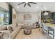 Spacious living room featuring a large sectional sofa and a view of the pool and patio at 6161 Anise Dr, Sarasota, FL 34238