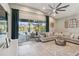Bright living room with a neutral palette, large sectional sofa, and seamless access to the outdoor pool area at 6161 Anise Dr, Sarasota, FL 34238