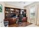 Home office featuring custom wood built-ins and hardwood floors at 6161 Anise Dr, Sarasota, FL 34238