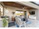 Charming outdoor patio with a grill, wicker seating, and a view of a tranquil lake at 6161 Anise Dr, Sarasota, FL 34238