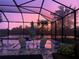 An inviting screened pool area at sunset is the ideal place to end the day and make memories at 6161 Anise Dr, Sarasota, FL 34238