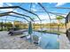 Beautiful pool with lounge seating, a table, and a serene view of the backyard and lake at 6161 Anise Dr, Sarasota, FL 34238
