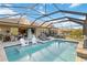 Relaxing pool area with lounge seating, patio furniture, and scenic backyard views at 6161 Anise Dr, Sarasota, FL 34238