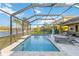 A screened pool area overlooks the lush backyard, which makes for the ultimate outdoor entertaining experience at 6161 Anise Dr, Sarasota, FL 34238