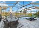 An inviting screened pool area features a seating area, a view of the water, and a tranquil outdoor experience at 6161 Anise Dr, Sarasota, FL 34238