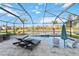 Inviting pool with lounge chairs, a spa, and a stunning view of the backyard and pond at 6161 Anise Dr, Sarasota, FL 34238