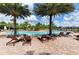 Resort-style pool with plenty of lounge chairs, umbrellas and palm trees, perfect for relaxation and socializing at 6161 Anise Dr, Sarasota, FL 34238