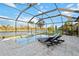 An inviting screened pool area with tanning chairs offers a tranquil view of the water at 6161 Anise Dr, Sarasota, FL 34238