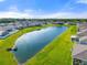 Aerial view of the property showcasing a peaceful pond and neighborhood at 6306 115Th E Ave, Parrish, FL 34219