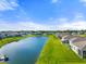 Property aerial view showcasing the beautiful pond and surrounding residences at 6306 115Th E Ave, Parrish, FL 34219