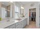 Elegant bathroom featuring double vanities, quartz countertops, and a glass-enclosed shower at 6306 115Th E Ave, Parrish, FL 34219