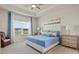 Comfortable primary bedroom featuring tray ceiling, a ceiling fan, and a scenic window view at 6306 115Th E Ave, Parrish, FL 34219