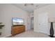 Bedroom featuring large tv, ceiling fan and access to other rooms in the home at 6306 115Th E Ave, Parrish, FL 34219