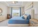 Well-lit primary bedroom featuring neutral decor, tray ceiling, and a scenic window view at 6306 115Th E Ave, Parrish, FL 34219