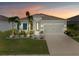 Charming single-story home featuring a well-maintained lawn, fresh landscaping, and a two-car garage at 6306 115Th E Ave, Parrish, FL 34219