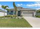 Inviting single-level home with a neatly manicured lawn, beautiful landscaping, and an attached two-car garage at 6306 115Th E Ave, Parrish, FL 34219