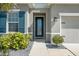 Close-up of a home's entryway, showing the front door and stylish landscaping at 6306 115Th E Ave, Parrish, FL 34219