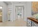Bright hallway leading to a spacious living area, with tile flooring and neutral wall colors at 6306 115Th E Ave, Parrish, FL 34219