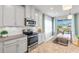 Bright kitchen with stainless steel appliances, granite countertops, and white cabinets at 6306 115Th E Ave, Parrish, FL 34219