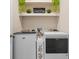 Laundry room with modern washer and dryer with overhead shelf at 6306 115Th E Ave, Parrish, FL 34219