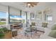 Bright living room with ceiling fan, large windows, and comfortable white seating at 6306 115Th E Ave, Parrish, FL 34219