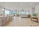Open-concept living area with a kitchen island, tile floors, and lots of natural light at 6306 115Th E Ave, Parrish, FL 34219