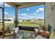 Relaxing screened patio with comfortable seating overlooking backyard and pond at 6306 115Th E Ave, Parrish, FL 34219