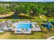 Community pool surrounded by palm trees, lounge chairs, and a nearby playground, creating a relaxing and Gathering-friendly outdoor space at 6306 115Th E Ave, Parrish, FL 34219