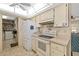 Functional kitchen featuring white appliances, ample cabinet space, and a well-lit dome ceiling, ideal for cooking at 6320 Tilly St, Englewood, FL 34224