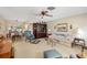Inviting living room with comfortable seating, decorative shelving, and ceiling fan at 6320 Tilly St, Englewood, FL 34224