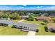 Aerial view of a single-story home surrounded by lush greenery and neighborhood at 6349 5Th Street E Cir, Bradenton, FL 34203