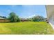 Expansive backyard features a large grassy area and mature trees at 6349 5Th Street E Cir, Bradenton, FL 34203