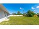 Spacious backyard featuring a large grassy area with a privacy fence at 6349 5Th Street E Cir, Bradenton, FL 34203