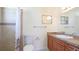 Bathroom featuring a shower with decorative tile, a toilet, and a vanity with a light-colored countertop at 6349 5Th Street E Cir, Bradenton, FL 34203