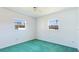 Light-filled bedroom with neutral walls, two windows providing natural light, and carpeted flooring at 6349 5Th Street E Cir, Bradenton, FL 34203