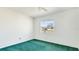 Bright bedroom features a ceiling fan, large window, and plush green carpet at 6349 5Th Street E Cir, Bradenton, FL 34203